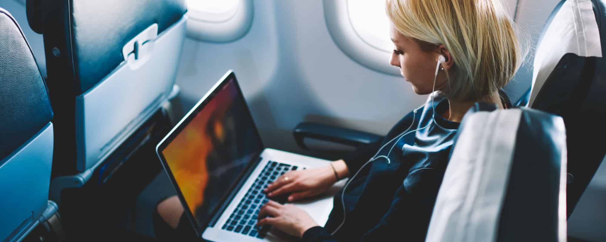 A person completing their work on a plane