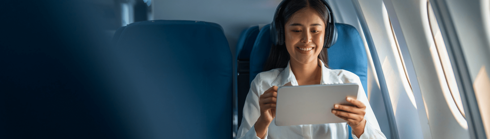 woman using tablet on airplane